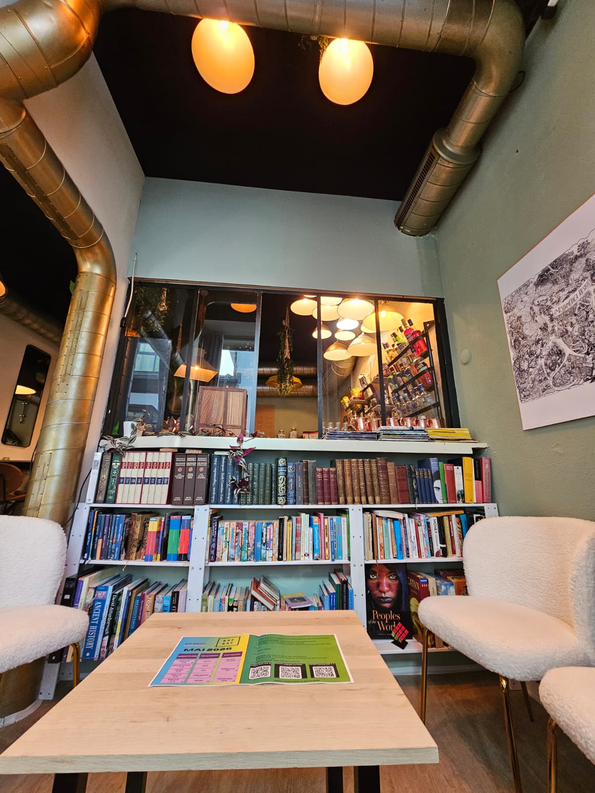 The KAFKAF reading nook — bookshelves, bouclé armchairs and warm lighting